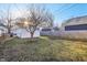 Backyard with grass, a detached garage, and a privacy fence, providing a secluded outdoor space and parking at 741 N Linwood Ave, Indianapolis, IN 46201
