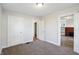 Bedroom with neutral carpet, two white doors and natural light at 741 N Linwood Ave, Indianapolis, IN 46201