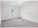 Neutral carpeted bedroom with natural light from one window at 741 N Linwood Ave, Indianapolis, IN 46201