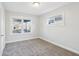 Neutral carpeted bedroom with natural light from two windows at 741 N Linwood Ave, Indianapolis, IN 46201