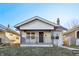 Charming single-story home featuring a cozy front porch with decorative railings and a well-maintained yard at 741 N Linwood Ave, Indianapolis, IN 46201