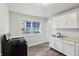 Kitchen with stove, double basin sink, window view and white cabinets at 741 N Linwood Ave, Indianapolis, IN 46201