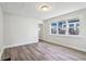 Open living room with laminate flooring and natural light from a large window at 741 N Linwood Ave, Indianapolis, IN 46201