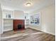 Cozy living room featuring hardwood floors, a fireplace with built-in shelving, and natural light at 741 N Linwood Ave, Indianapolis, IN 46201