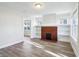 Bright living room featuring hardwood floors, fireplace with built-in shelving at 741 N Linwood Ave, Indianapolis, IN 46201