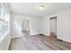 Bright living room featuring wood look floors and natural light from multiple windows at 741 N Linwood Ave, Indianapolis, IN 46201