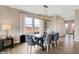 Dining area featuring a dark wood table, modern lighting, and a view of the outdoors at 7512 Manor Lake Ln, Indianapolis, IN 46268