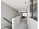 Upstairs hallway leads to a cozy living area with large windows and comfortable seating at 7523 Fallsworth Dr, Avon, IN 46123