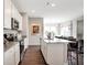 Modern kitchen showcasing white cabinetry, stainless steel appliances, and a central island perfect for entertaining at 7523 Fallsworth Dr, Avon, IN 46123