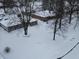 An aerial view of a snow-covered neighborhood showcases cozy homes at 7816 E St Joseph St, Indianapolis, IN 46219