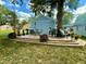 Landscaped backyard featuring a raised deck and an outdoor dining area at 7816 E St Joseph St, Indianapolis, IN 46219