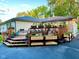 A large, wooden backyard deck features built in planters and pots of flowers at 7816 E St Joseph St, Indianapolis, IN 46219