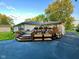 A large, wooden backyard deck features built in planters and pots of flowers at 7816 E St Joseph St, Indianapolis, IN 46219