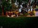 Backyard area with string lights illuminating multiple seating areas around a fire pit, creating an inviting ambiance at 7816 E St Joseph St, Indianapolis, IN 46219
