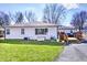 Backyard of a home with a well-maintained lawn and a wooden deck, offering outdoor relaxation and entertainment space at 7816 E St Joseph St, Indianapolis, IN 46219