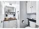 Well-lit bathroom featuring modern fixtures, wood countertops, and stylish storage solutions at 7816 E St Joseph St, Indianapolis, IN 46219