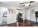 Bedroom with hardwood floors, mirrored closet doors, and ceiling fan at 7816 E St Joseph St, Indianapolis, IN 46219