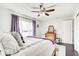 Bright bedroom with hardwood floors, ceiling fan, large window, and natural light at 7816 E St Joseph St, Indianapolis, IN 46219