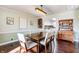 Traditional dining room with hardwood floors, modern lighting, wine rack, and detailed wood furnishings at 7816 E St Joseph St, Indianapolis, IN 46219