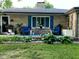 Charming front porch with seating and beautiful landscaping, creating a welcoming entry to the home at 7816 E St Joseph St, Indianapolis, IN 46219
