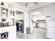 Bright kitchen with stainless appliances is viewed, along with the utility area that includes a washer and dryer at 7816 E St Joseph St, Indianapolis, IN 46219