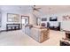 Open living room with neutral carpeting, a ceiling fan, and a view into other rooms at 7816 E St Joseph St, Indianapolis, IN 46219