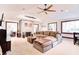 Inviting living room featuring a stone fireplace, large sectional sofa, and decorative ceiling fan at 7816 E St Joseph St, Indianapolis, IN 46219