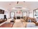 Warm living room with a stone fireplace, sectional couch, and hardwood furniture at 7816 E St Joseph St, Indianapolis, IN 46219