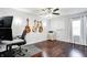 Office space with wood floors, work station, and a wall-mounted guitar display at 7816 E St Joseph St, Indianapolis, IN 46219