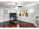 Home office featuring multiple monitors, guitars, and dark wood floors at 7816 E St Joseph St, Indianapolis, IN 46219