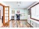 Bright home office with built-in storage, a large window, and a ceiling fan at 7816 E St Joseph St, Indianapolis, IN 46219