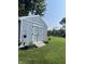 A well-maintained shed is surrounded by lush green grass and potted plants at 7816 E St Joseph St, Indianapolis, IN 46219