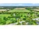 Lush aerial showcases a sprawling property with verdant fields and picturesque buildings at 905 S Maple St, Fortville, IN 46040