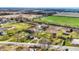 An aerial perspective of the property featuring serene ponds, walking paths, and scattered residences at 905 S Maple St, Fortville, IN 46040