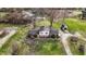Aerial view of a house with an expansive yard, pond, detached garage, and room to roam at 905 S Maple St, Fortville, IN 46040