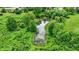 An aerial view of a lush pond surrounded by trees and greenery at 905 S Maple St, Fortville, IN 46040