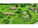 An aerial view of a sprawling property with homes, outbuildings, and a picturesque pond at 905 S Maple St, Fortville, IN 46040