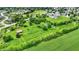 Aerial shows property with green field, pond, and buildings at 905 S Maple St, Fortville, IN 46040