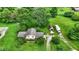 An aerial view of a home with a sprawling lawn, mature trees, and a private setting at 905 S Maple St, Fortville, IN 46040