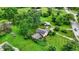 An aerial view of a charming home surrounded by lush greenery and mature trees at 905 S Maple St, Fortville, IN 46040