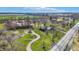 Beautiful aerial view showcases a sprawling property featuring mature trees, winding paths, and a tranquil pond at 905 S Maple St, Fortville, IN 46040