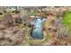 Drone photo showing the property's pond with walking paths and surrounding foliage near homes at 905 S Maple St, Fortville, IN 46040