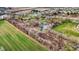 A panoramic aerial view of the property with a scenic pond and adjacent green and tilled farmland at 905 S Maple St, Fortville, IN 46040