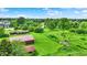 An aerial view of a property with a home, outbuildings, and mature trees at 905 S Maple St, Fortville, IN 46040