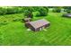 An aerial view of a large outbuilding on a well-maintained grassy lot at 905 S Maple St, Fortville, IN 46040
