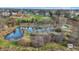 An aerial shot of a serene pond surrounded by bare trees, near a quiet neighborhood at 905 S Maple St, Fortville, IN 46040