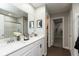 Bright bathroom with double sinks, quartz countertops, and a walk-in shower with a glass door at 9709 Tampico Chase, Fishers, IN 46040