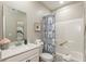Bright bathroom with white vanity, quartz countertop, blue patterned shower curtain, and decorative accents at 9709 Tampico Chase, Fishers, IN 46040