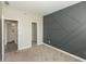 Spacious bedroom boasting stylish gray accent wall and neutral carpet with adjacent closet at 9709 Tampico Chase, Fishers, IN 46040