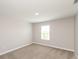 Neutral bedroom boasts carpeted floors, clean lines, and a window at 9709 Tampico Chase, Fishers, IN 46040